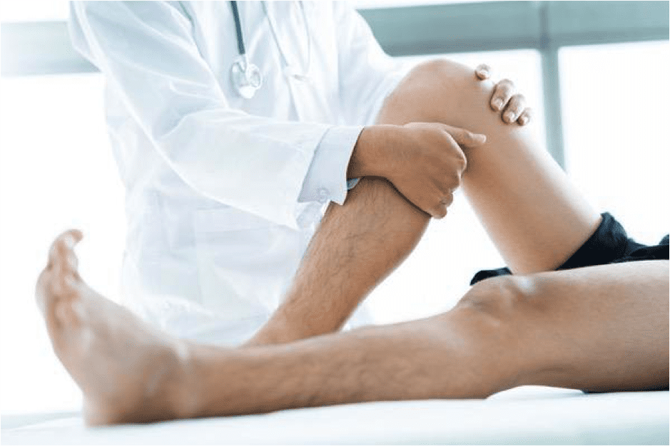 a doctor feeling and examining a man's knee and leg