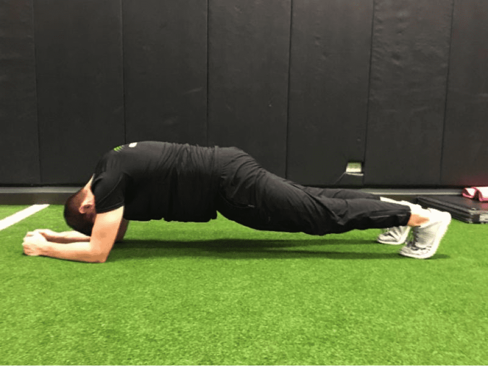 a man doing a plank with his head facing downward in the right position