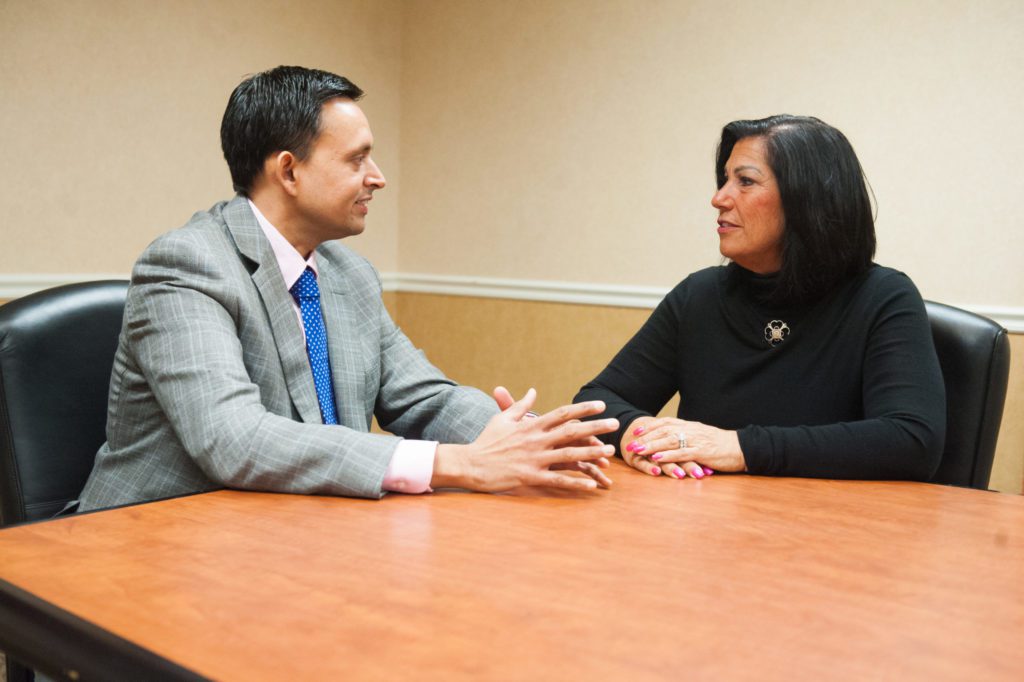 Dr. Shah discussing outpatient joint replacement surgery with his patient JoAnn