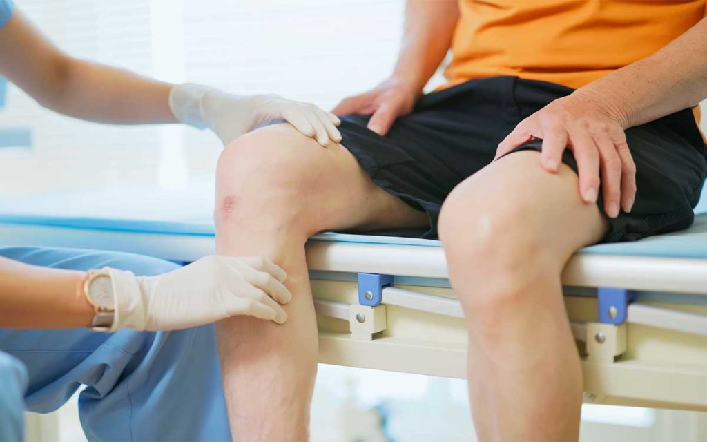 man consults a doctor about options for bone-on-bone knee pain relief