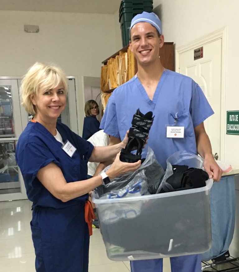 Dr. Ptaszek holding a donated brace that will be used for patients
