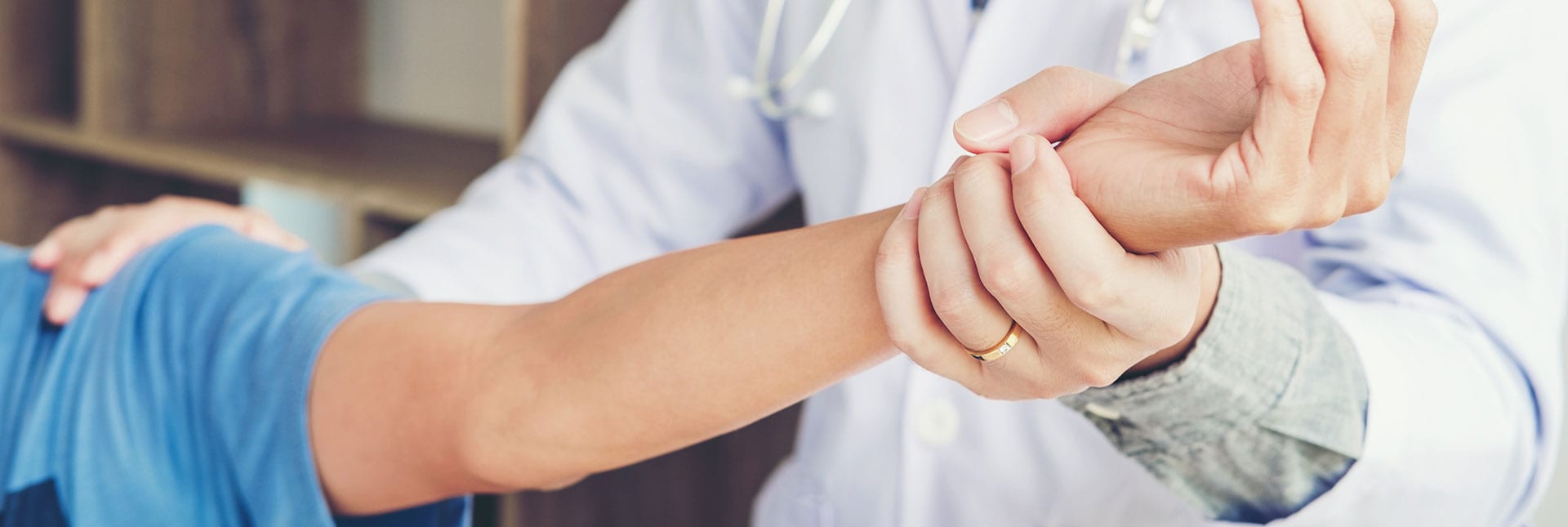 Doctor examines patient's arm