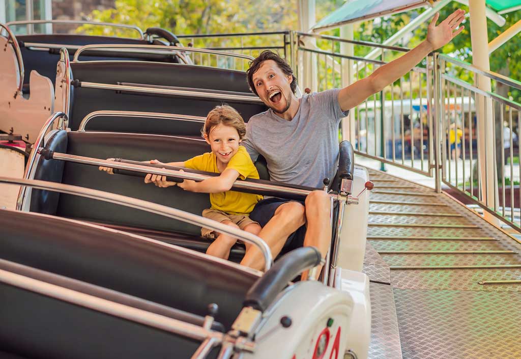 Father and son riding a roller coaster