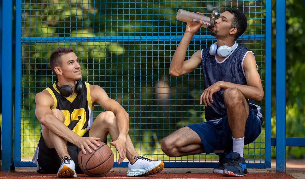 Two athletes taking a water break