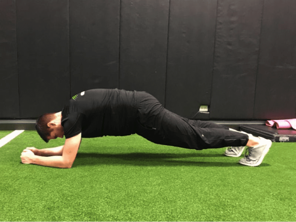 a man doing a plank with his back mildly arched