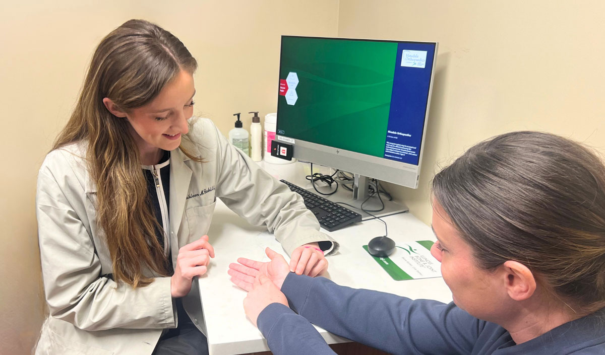 Dr. Cathleen Cahill working with a patient's hand