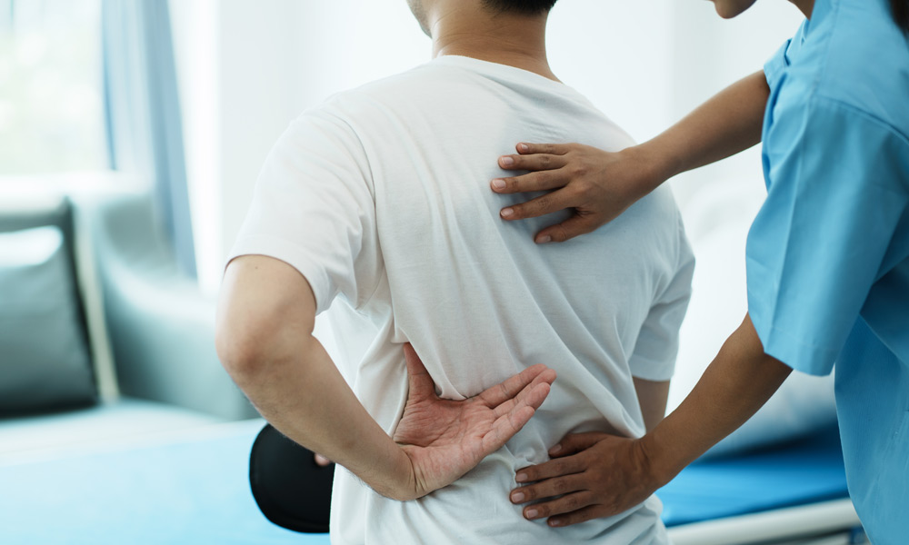 Doctor treating patient's back problem