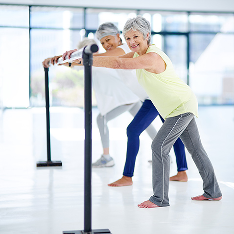 Women working out at an exercise bar