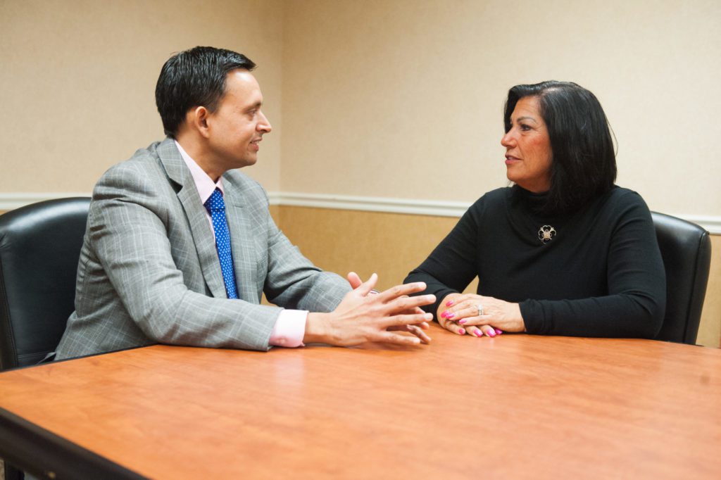 Dr. Shah discussing outpatient joint replacement surgery with his patient JoAnn.