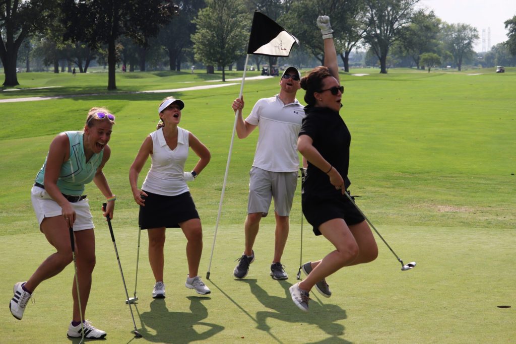 (L-R) Maggie Sketch, IBJI Senior Marketing Manager; Julie DiGiovanna, PT, Director of OrthoSync Clinical Services; and Mike Losch, IBJI Assistant Director or Rehab celebrate a long putt by Amy Illarde, IBJI Director of Communications and Employee Engagement.