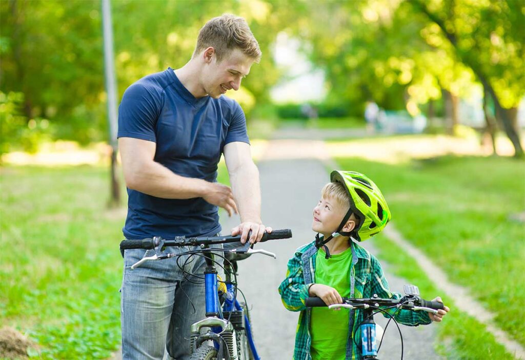 Father teaching son to ride a bicycle
