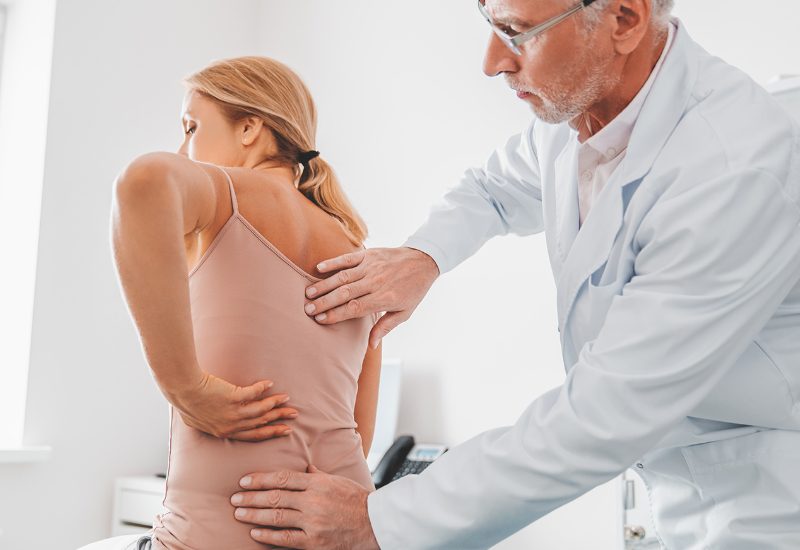 doctor evaluating back pain