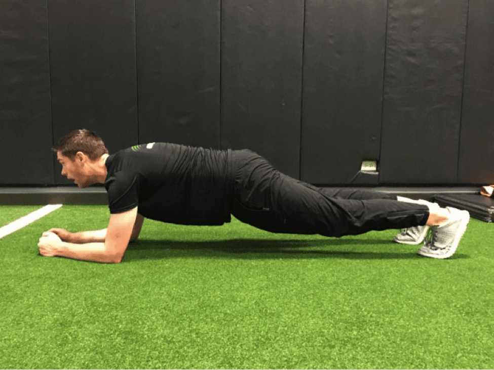 a man doing a plank incorrectly and reaching his neck outwards