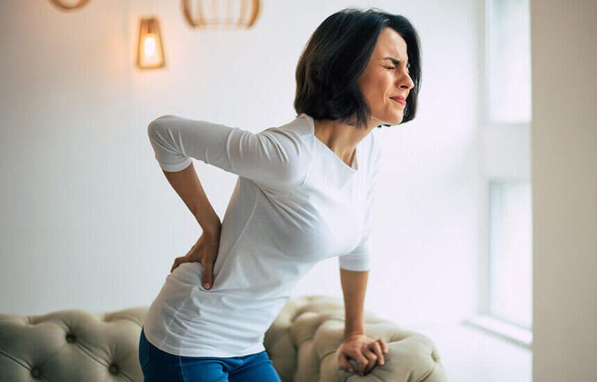 woman gripping back in pain
