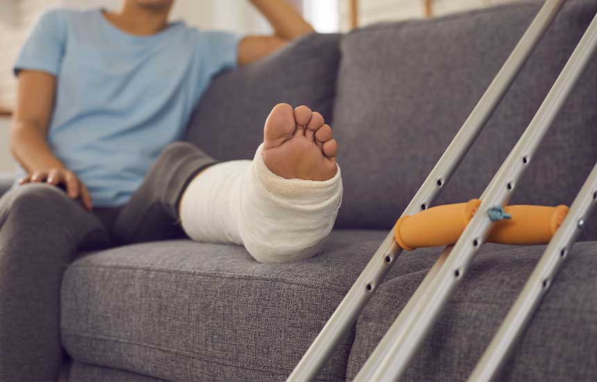 woman resting injured leg on the couch