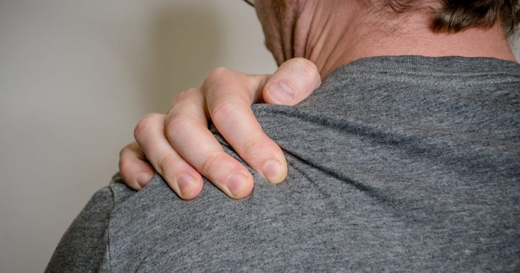 man suffering from shoulder pain causes