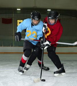 Young hockey players battle for the puck